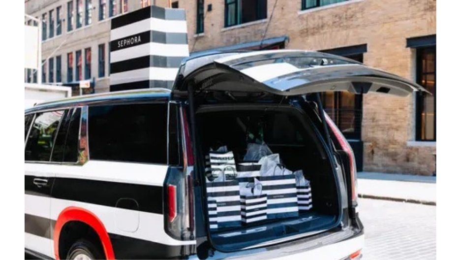 Sephora-branded Lyft vehicle with open trunk and Sephora bags filled in the trunk. 
